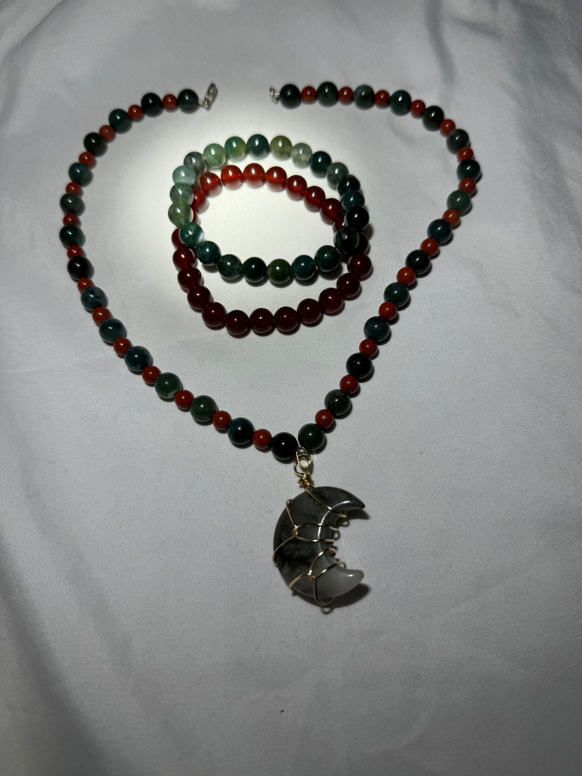 Beaded necklace with a pendant on a white background